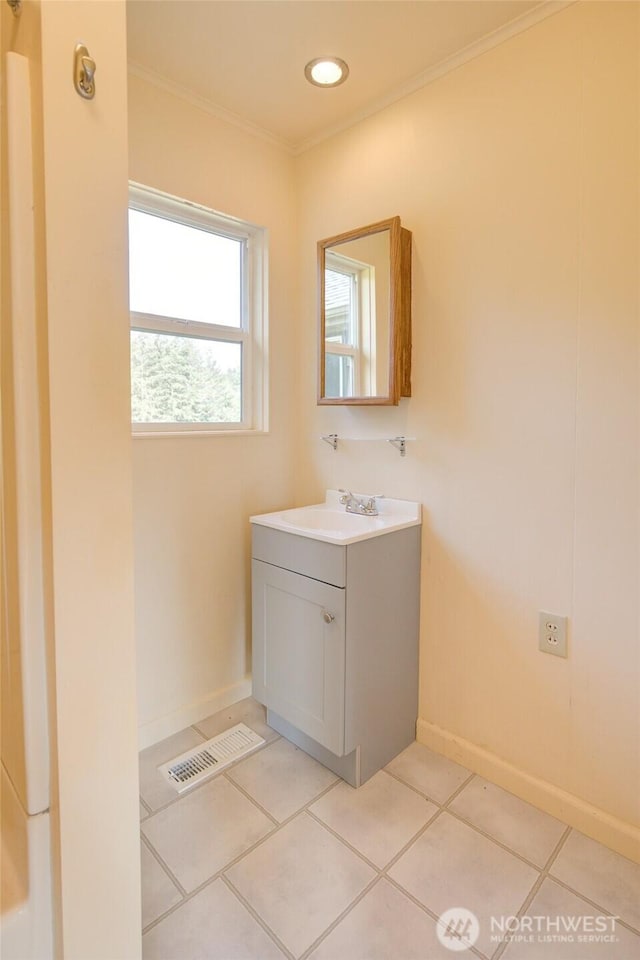 bathroom featuring ornamental molding, vanity, baseboards, and tile patterned flooring