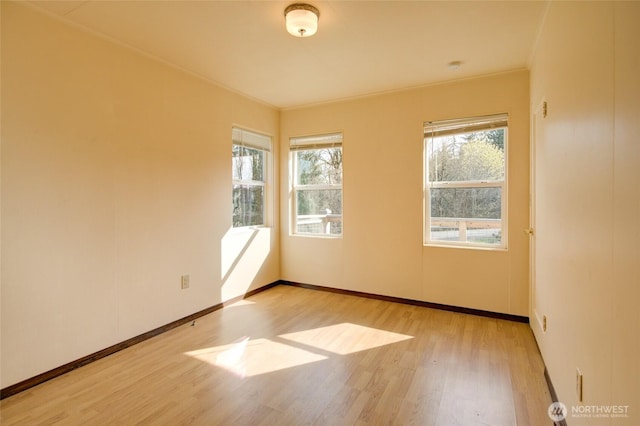 unfurnished room with wood finished floors and baseboards