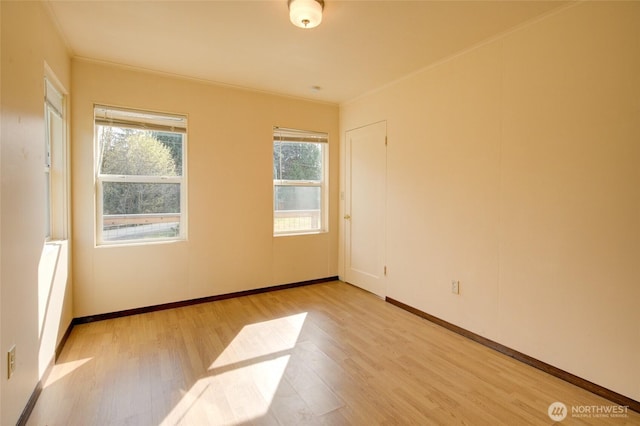 empty room featuring light wood-style flooring and baseboards