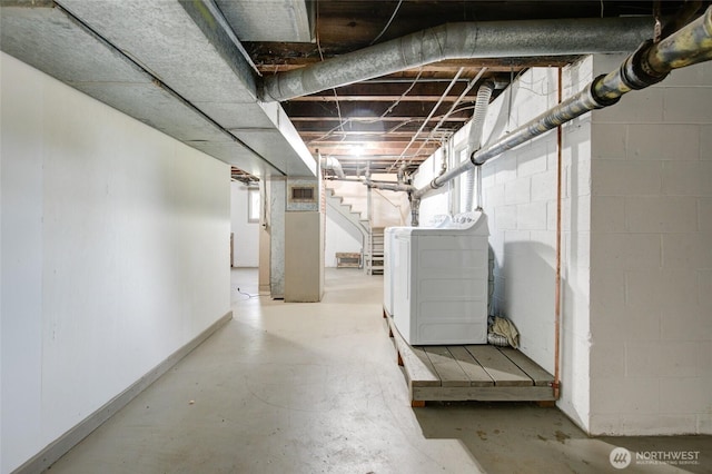 basement with stairs, separate washer and dryer, baseboards, and concrete block wall