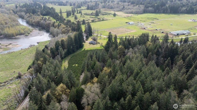 aerial view of property's location featuring rural landscape and a forest