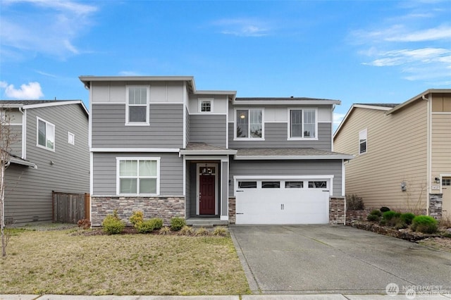 14123 67th Ave E, Puyallup, WA 98373 - view of front of home with an attached garage, concrete driveway, stone siding, and board and batten siding