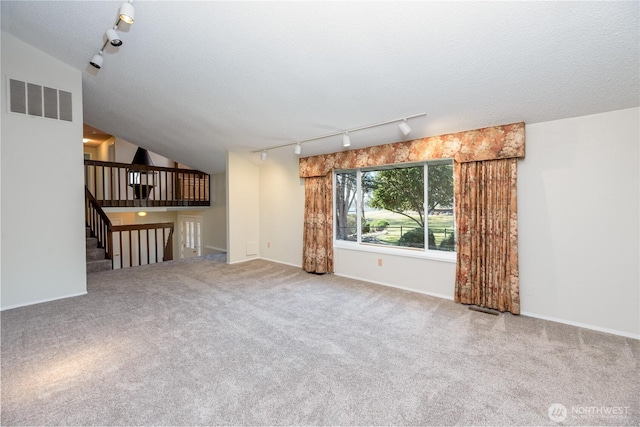 3579 NW Dodson Rd, Ephrata, WA 98823 - unfurnished living room with track lighting, carpet flooring, baseboards, and a textured ceiling