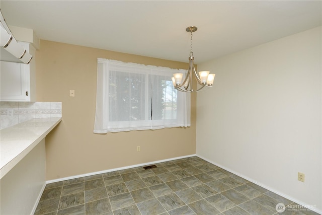 3579 NW Dodson Rd, Ephrata, WA 98823 - unfurnished dining area featuring a chandelier and baseboards