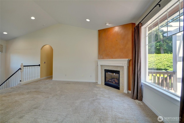 18423 Hawksview Dr, Arlington, WA 98223 - unfurnished living room with light colored carpet, a fireplace, arched walkways, recessed lighting, and lofted ceiling