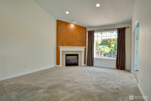 18423 Hawksview Dr, Arlington, WA 98223 - unfurnished living room with light carpet, a tiled fireplace, baseboards, and recessed lighting