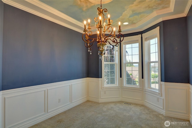 18423 Hawksview Dr, Arlington, WA 98223 - unfurnished dining area with healthy amount of natural light, a chandelier, a wainscoted wall, carpet, and crown molding