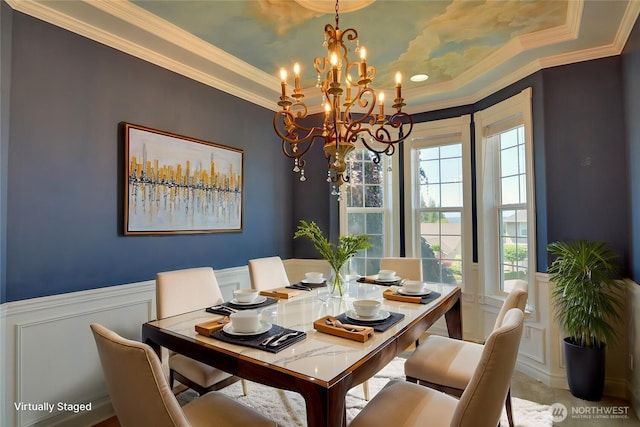 18423 Hawksview Dr, Arlington, WA 98223 - dining room featuring a chandelier, wainscoting, crown molding, a decorative wall, and a tray ceiling