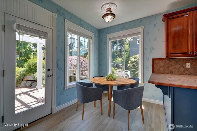 18423 Hawksview Dr, Arlington, WA 98223 - dining area featuring light wood-style flooring, wallpapered walls, and baseboards