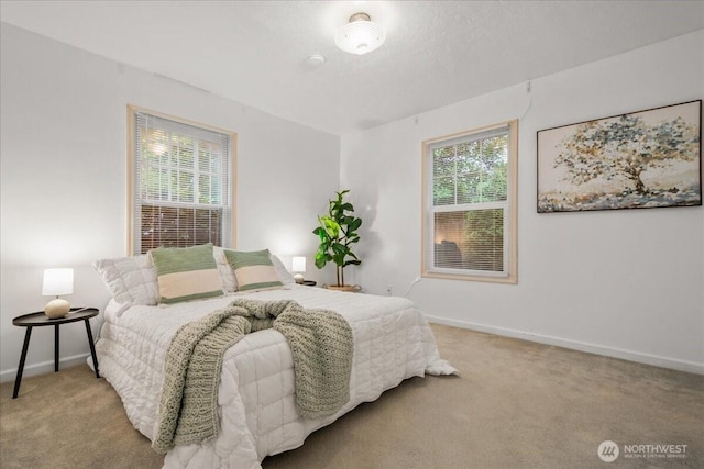 carpeted bedroom featuring baseboards
