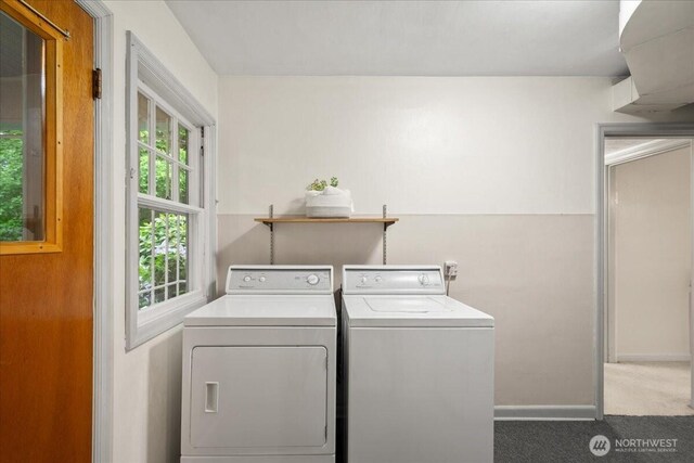 washroom featuring washer and dryer, carpet flooring, and baseboards