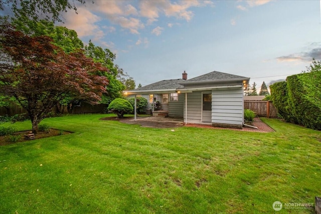 rear view of property with a patio area and a chimney