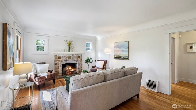 10735 Whitman Ave N, Seattle, WA 98133 - living area with plenty of natural light, wood finished floors, and a stone fireplace