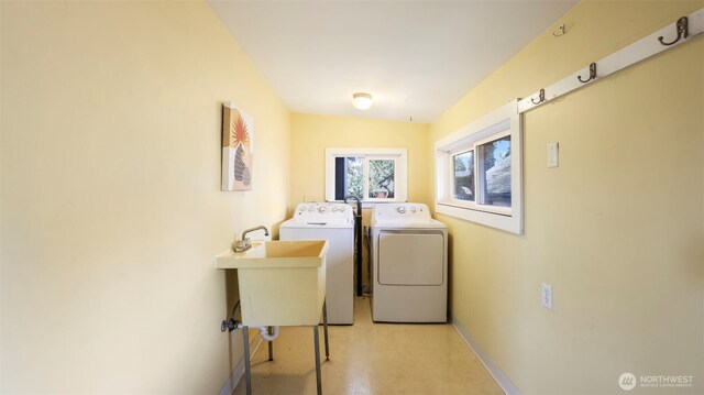10735 Whitman Ave N, Seattle, WA 98133 - clothes washing area with washer and clothes dryer and baseboards