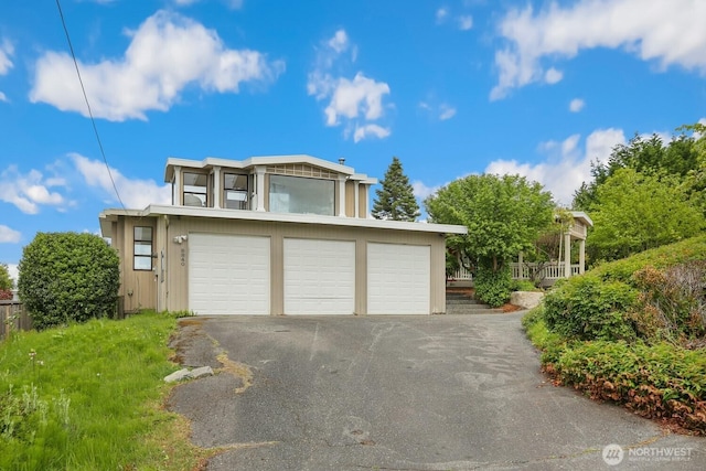 8840 NE 24th St, Clyde Hill, WA 98004 - view of front facade featuring an attached garage and asphalt driveway