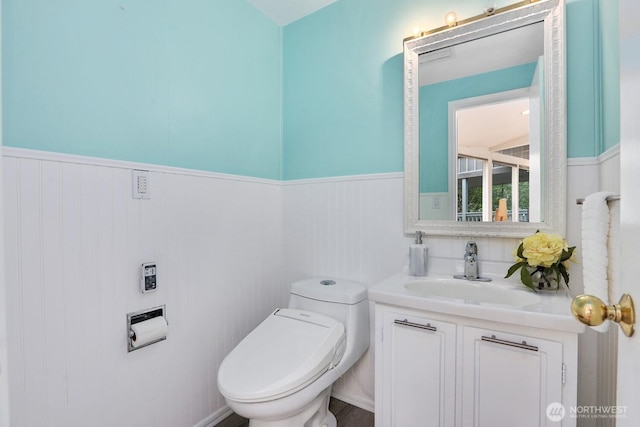 8840 NE 24th St, Clyde Hill, WA 98004 - half bathroom with a wainscoted wall, vanity, and toilet