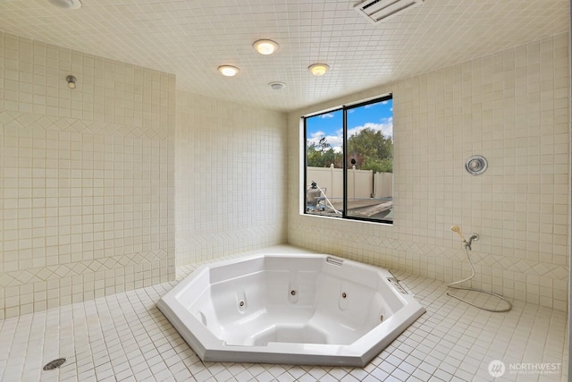 8840 NE 24th St, Clyde Hill, WA 98004 - full bath featuring tile walls, a whirlpool tub, and tile patterned floors