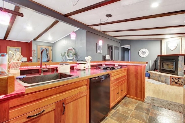 kitchen featuring dishwasher, a sink, stainless steel gas cooktop, decorative light fixtures, and stone finish floors