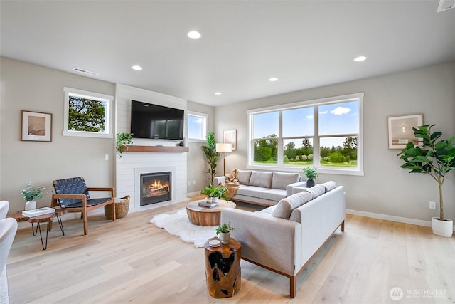 17711 11th Ave NE, Arlington, WA 98223 - living room featuring plenty of natural light, a large fireplace, light wood-style floors, recessed lighting, and baseboards