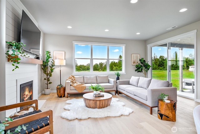 17711 11th Ave NE, Arlington, WA 98223 - living room with plenty of natural light, wood finished floors, a glass covered fireplace, recessed lighting, and baseboards