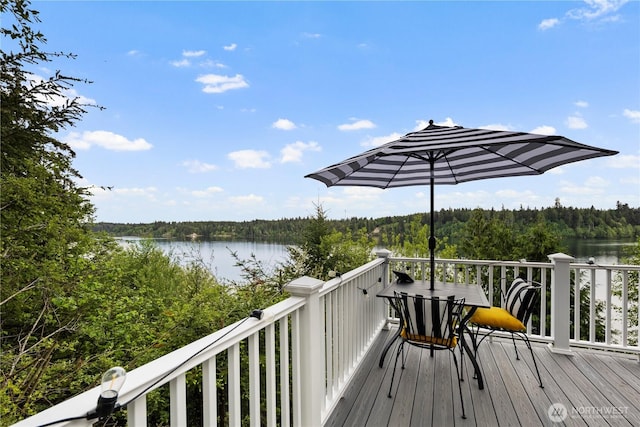 deck featuring a water view and a wooded view