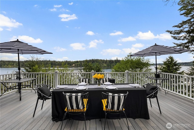 deck featuring a water view and a view of trees