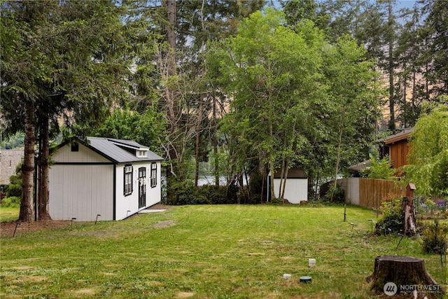 view of yard featuring an outbuilding and a shed