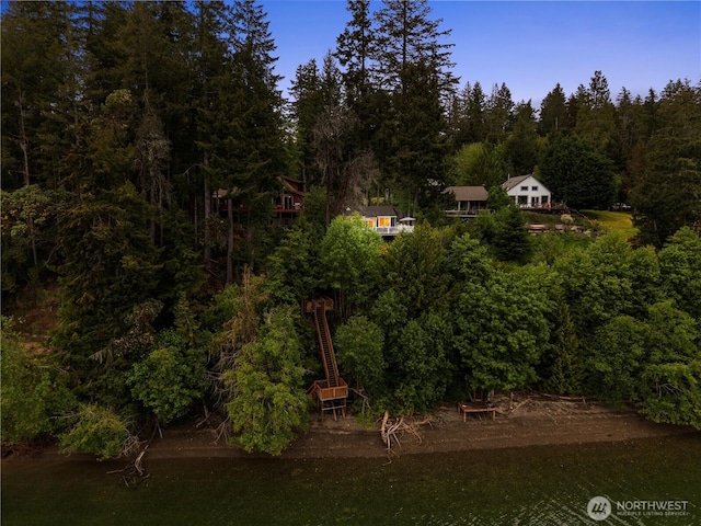 aerial view of property and surrounding area featuring a forest