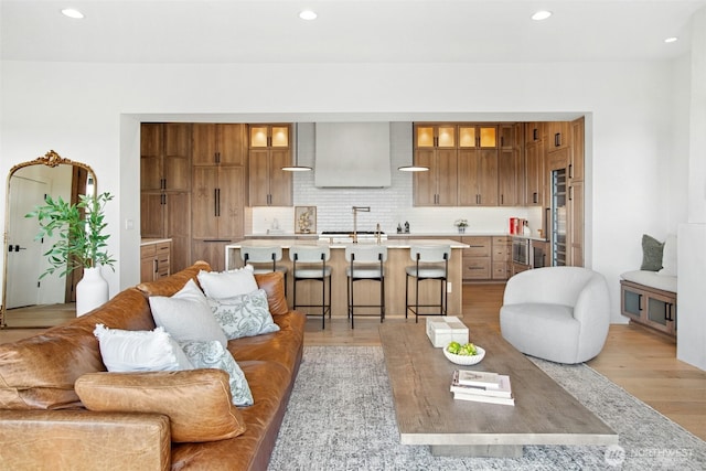 living area with light wood finished floors and recessed lighting