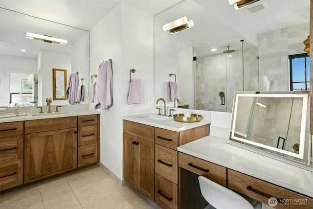 bathroom featuring a shower stall, tile patterned flooring, and two vanities