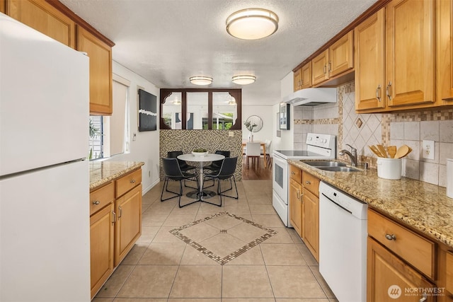 23516 20th Ave W, Bothell, WA 98021 - kitchen featuring white appliances, light tile patterned flooring, tasteful backsplash, a sink, and brown cabinetry
