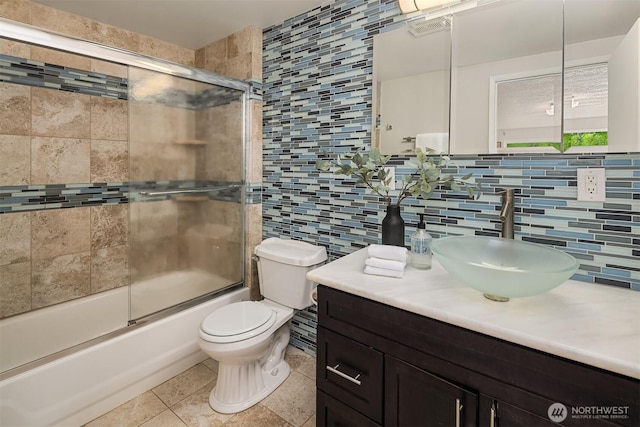 23516 20th Ave W, Bothell, WA 98021 - bathroom with tile walls, decorative backsplash, toilet, combined bath / shower with glass door, and vanity