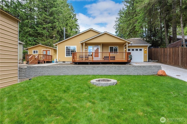 320 E Lakeview Dr, Grapeview, WA 98546 - view of front of home with an attached garage, an outdoor fire pit, a wooden deck, driveway, and crawl space