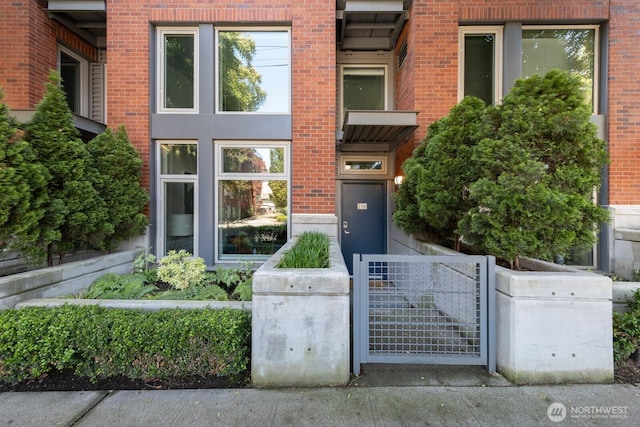 530 Broadway E Unit 124, Seattle, WA 98102 - view of exterior entry featuring brick siding and a gate