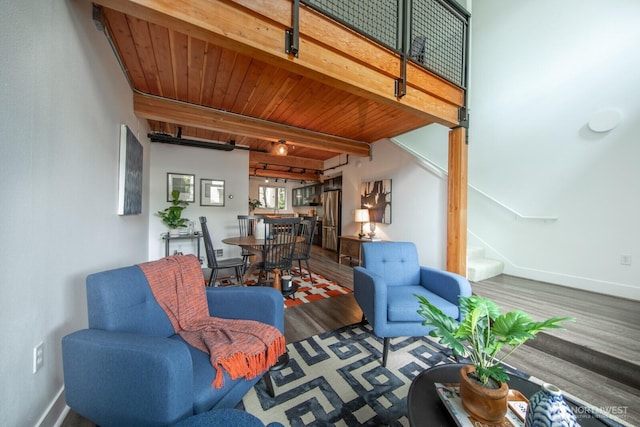 530 Broadway E Unit 124, Seattle, WA 98102 - living area with wood finished floors, stairs, baseboards, and wood ceiling with exposed beams