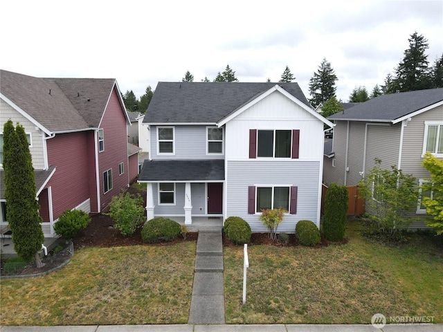 3084 Sheaser Way, Dupont, WA 98327 - traditional home with covered porch, board and batten siding, a front yard, and a shingled roof