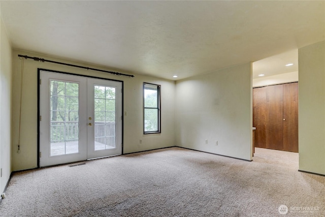 6605 Cooper Point Rd NW, Olympia, WA 98502 - carpeted spare room featuring french doors and recessed lighting