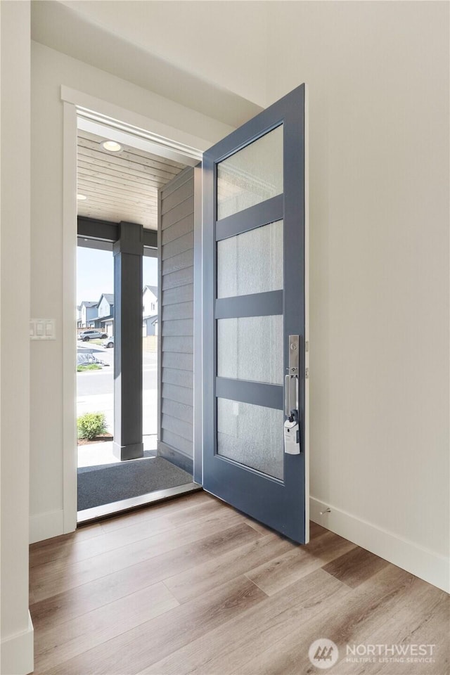 entrance foyer with wood finished floors and baseboards