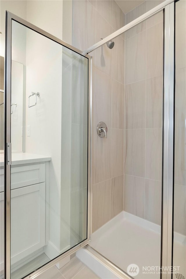 bathroom featuring a stall shower and vanity