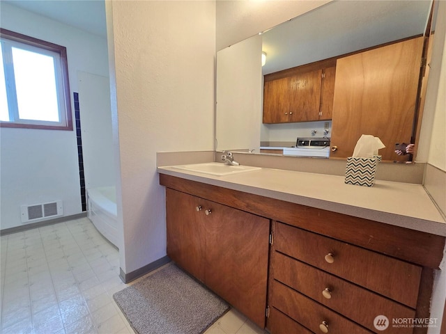 810 H St, Forks, WA 98331 - bathroom featuring vanity, a bathtub, and baseboards
