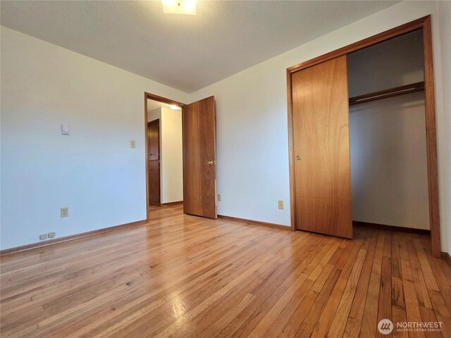 810 H St, Forks, WA 98331 - unfurnished bedroom with light wood-type flooring, baseboards, and a closet