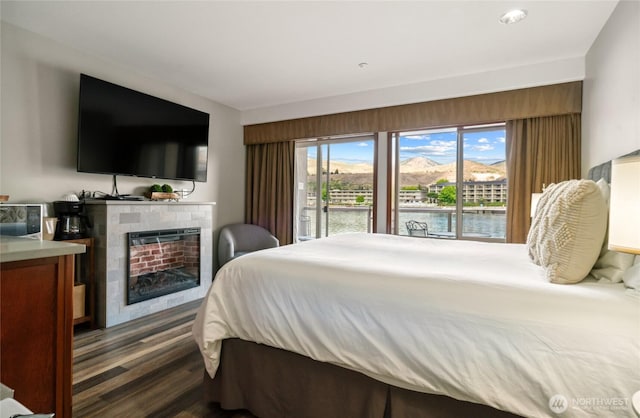 322 W Woodin Ave Unit 711, Chelan, WA 98816 - bedroom featuring dark wood-style flooring, a fireplace, and access to outside