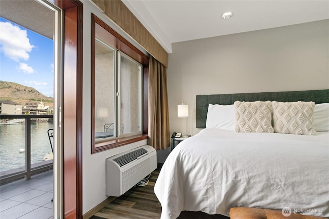 322 W Woodin Ave Unit 711, Chelan, WA 98816 - bedroom featuring an AC wall unit, access to outside, a water view, and wood finished floors