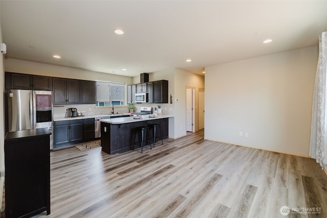 2450 Zeeden Way, Bremerton, WA 98310 - kitchen with stainless steel appliances, light wood finished floors, a sink, light countertops, and a peninsula