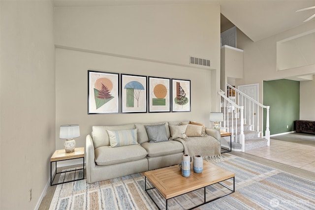 12015 SE 312th Pl Unit 7D, Auburn, WA 98092 - tiled living room featuring a high ceiling, stairway, baseboards, and ceiling fan