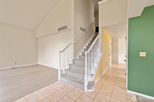 12015 SE 312th Pl Unit 7D, Auburn, WA 98092 - stairs with high vaulted ceiling, tile patterned floors, and baseboards