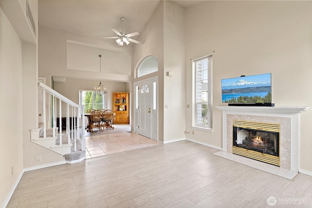 12015 SE 312th Pl Unit 7D, Auburn, WA 98092 - entrance foyer with wood finished floors, a chandelier, a high end fireplace, a high ceiling, and baseboards