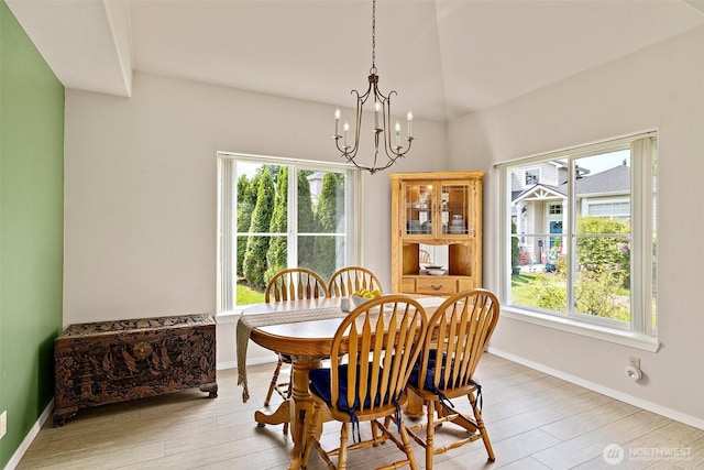 12015 SE 312th Pl Unit 7D, Auburn, WA 98092 - dining area with healthy amount of natural light, a chandelier, wood finished floors, and baseboards
