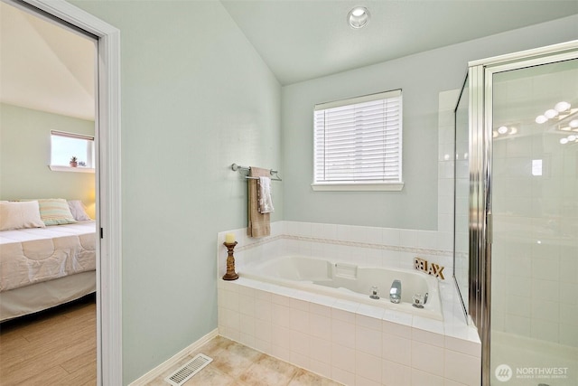 12015 SE 312th Pl Unit 7D, Auburn, WA 98092 - ensuite bathroom with a garden tub, a stall shower, baseboards, and lofted ceiling