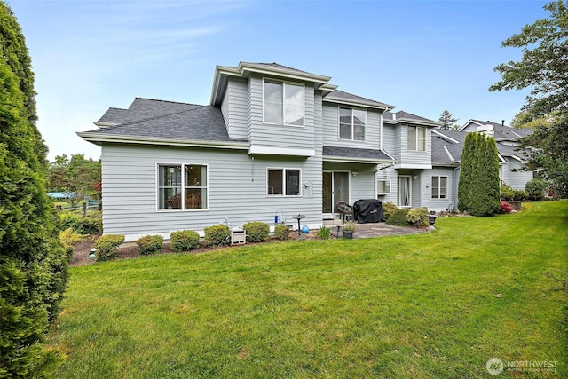 12015 SE 312th Pl Unit 7D, Auburn, WA 98092 - back of property featuring a patio, a lawn, and roof with shingles